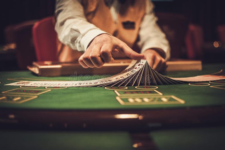 croupier-behind-gambling-table-casino-894755833