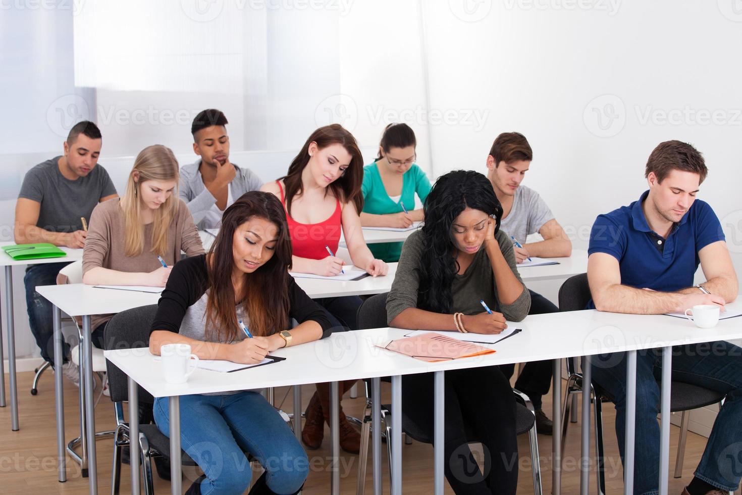 college-students-writing-at-desk-photo